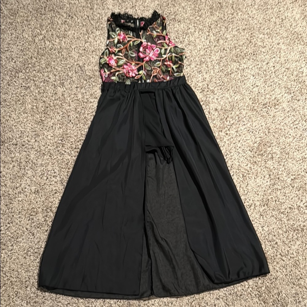 Black romper with sheer floral top and black overlay to feet